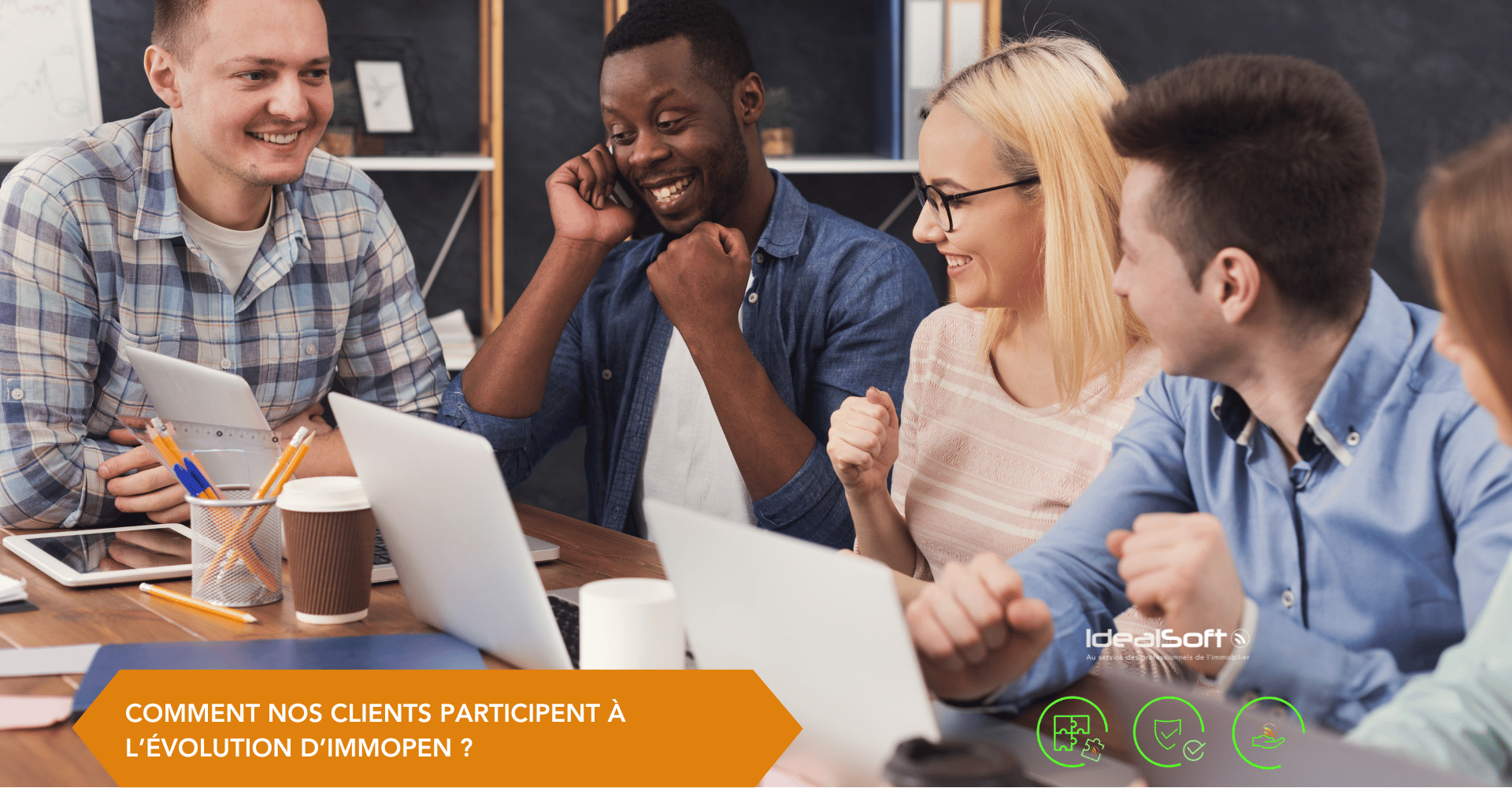 Équipe souriante devant un ordinateur, illustrant la participation des clients à l’évolution d’ImmOpen